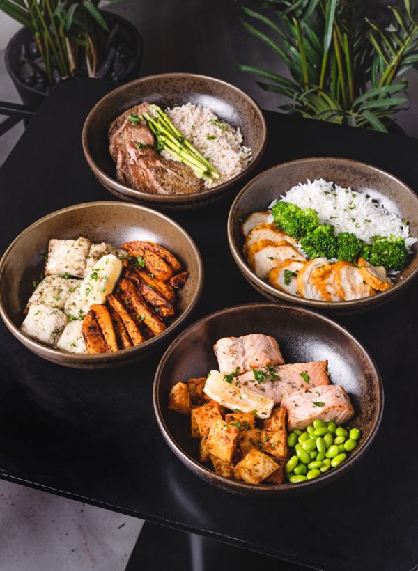 cooked food on black ceramic bowls
